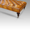 Large deep buttoned leather stool corner