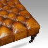 Large deep buttoned leather stool corner leg