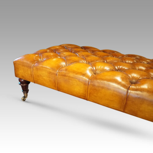 Large deep buttoned leather stool edge