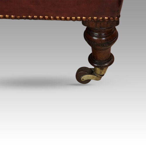Victorian red leather easy chair leg