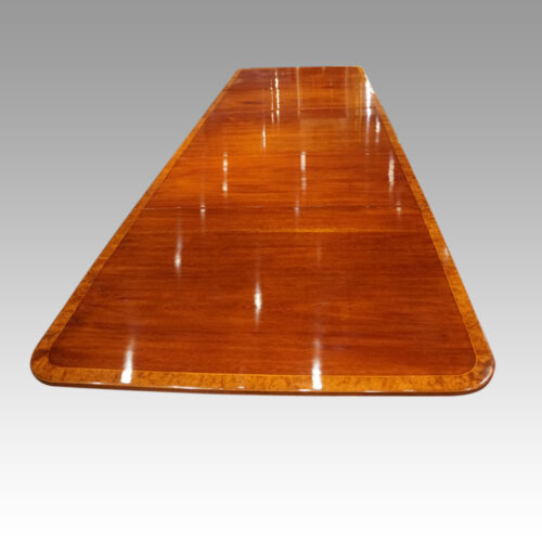 George V mahogany triple pillar dining table from end