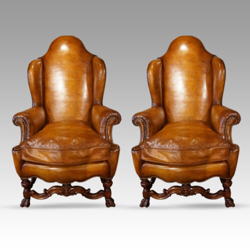 Pair of walnut leather wing chairs