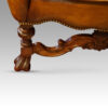 Pair of walnut leather wing chairs front of leg