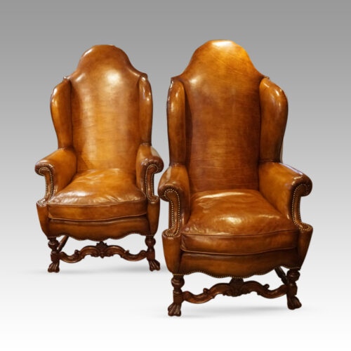 Pair of walnut leather wing chairs front view