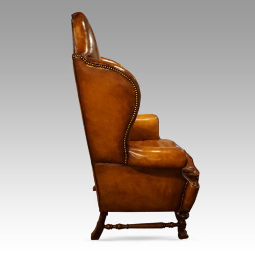 Pair of walnut leather wing chairs side