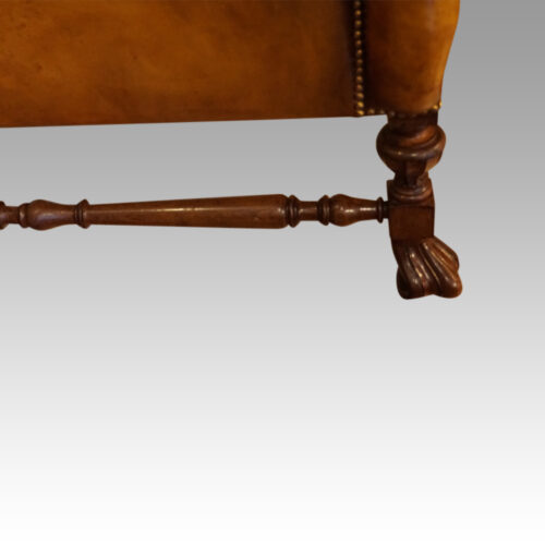 Pair of walnut leather wing chairs side rail