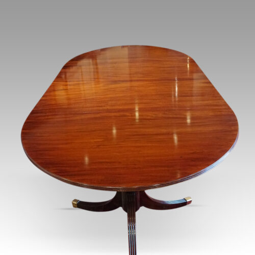 Regency style mahogany twin pedestal dining table end view