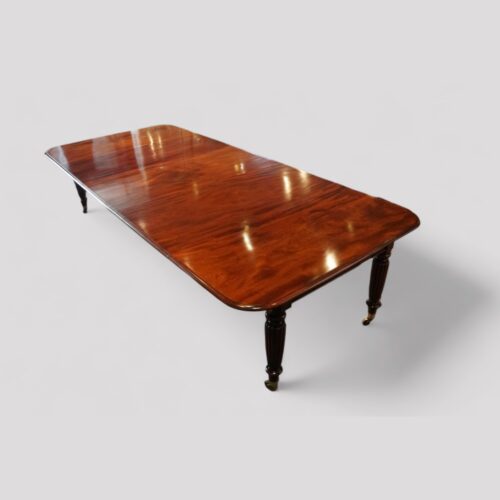 Regency mahogany extending dining table at angle