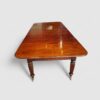 Regency mahogany extending dining table end view
