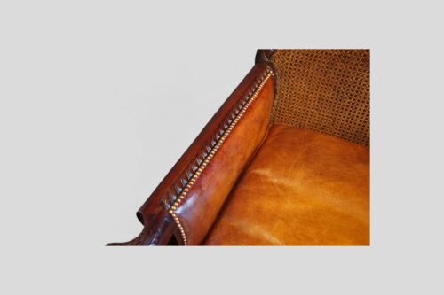 Pair of Edwardian leather club chairs arm rail