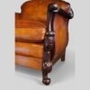 Pair of Edwardian leather club chairs front leg