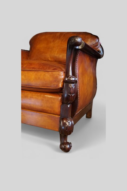 Pair of Edwardian leather club chairs front leg