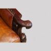 Pair of Edwardian leather club chairs hand grip