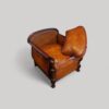 Pair of Edwardian leather club chairs showing back cushion off