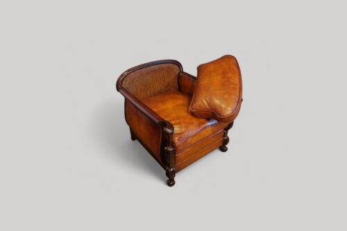 Pair of Edwardian leather club chairs showing back cushion off