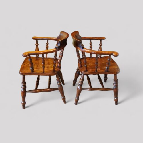 Pair of Edwardian captains chairs side view