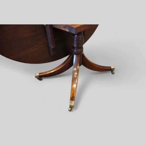 Oval mahogany cross banded dining table leg and castor