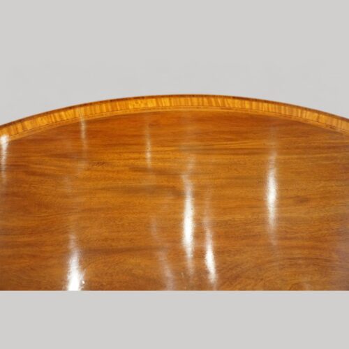 Oval mahogany cross banded dining table top detail