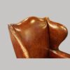 Tortoiseshell leather wing chair shaped back