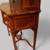 Edwardian inlaid serpentine bookcase base side detail