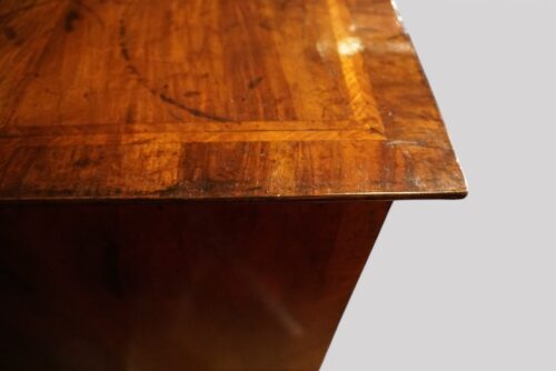 Antique walnut chest on stand top corner