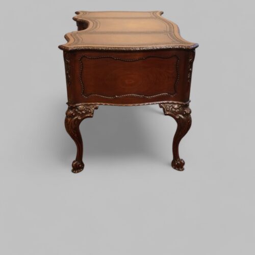 Chippendale style mahogany serpentine desk end view