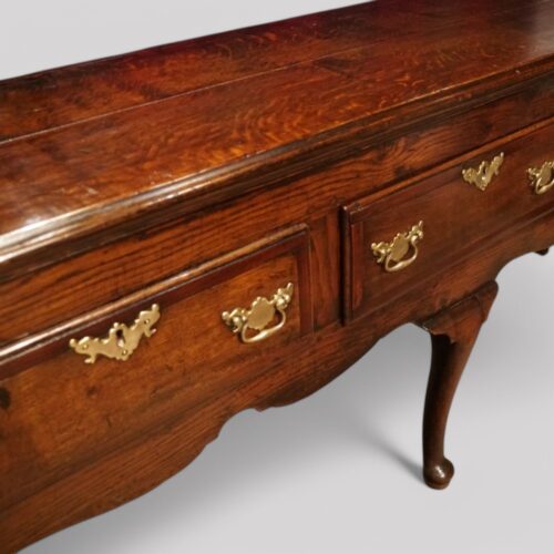 Antique oak cabriole leg dresser base at angle