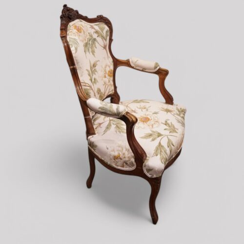 Pair of French walnut armchairs at angle