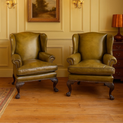 Antique green leather Irish wingchairs