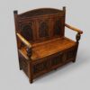 Edwardian golden oak settle at angle