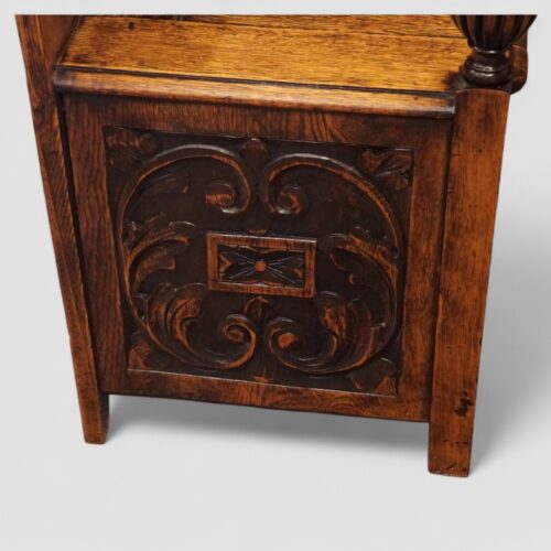 Edwardian golden oak settle end carved panel