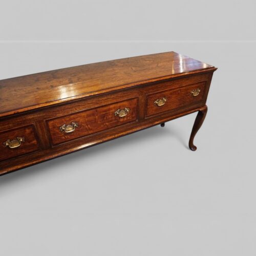 Antique oak cabriole leg dresser base at angle