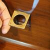 Brass bound yew wood serving cabinet handle lifted