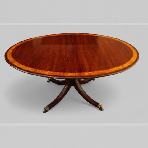 Sheraton style mahogany oval extending dining table closed