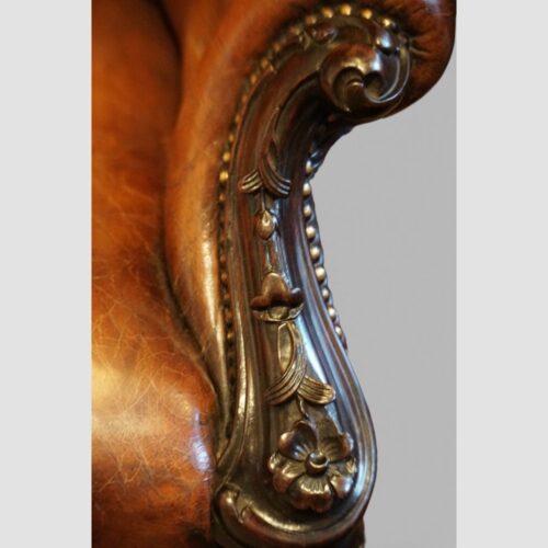 Pair of Victorian button leather reading chairs carving detail