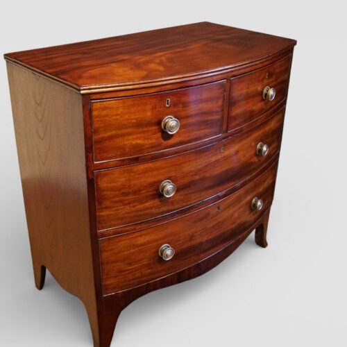 Regency mahogany small bow front chest at angle