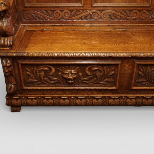 Victorian carved oak settle carved lion head panel