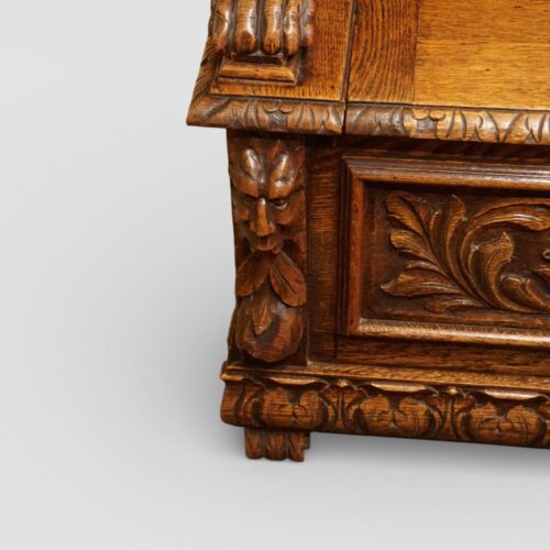 Victorian carved oak settle green man