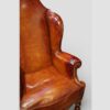 Pair of Edwardian leather wing back chairs arm and wing