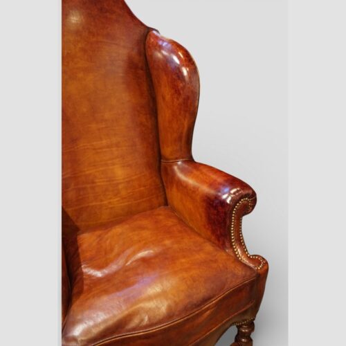 Pair of Edwardian leather wing back chairs arm and wing