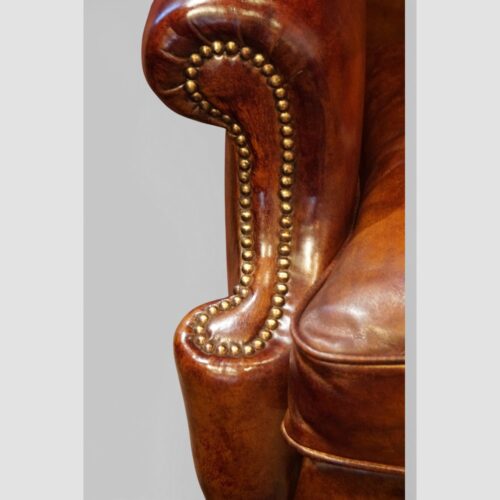Pair of Edwardian leather wing back chairs arm detail