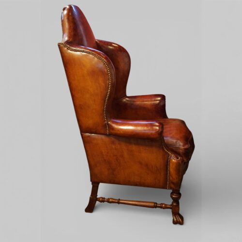 Pair of Edwardian leather wing back chairs side