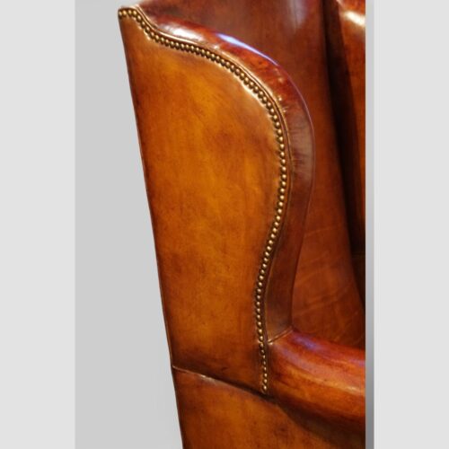 Pair of Edwardian leather wing back chairs wing detail