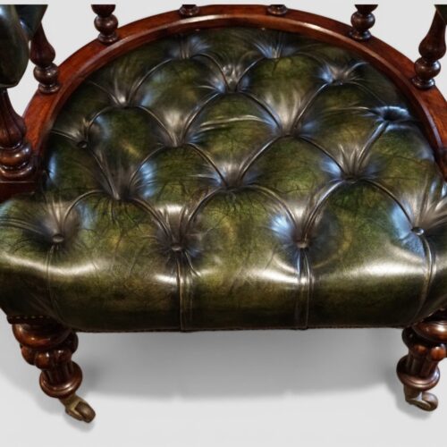 Pair of Victorian green leather tub chairs buttoned seats