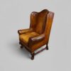 Pair of William and Mary leather wing chairs angle