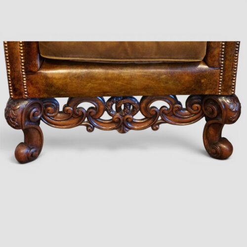 Pair of William and Mary leather wing chairs front rail and legs