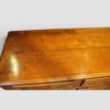Antique fruitwood dresser base top detail