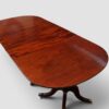 Antique mahogany 3 pillar dining table closed with no leaves end view