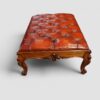 Large Victorian walnut coffee table and stool creating a striking centrepiece in a living room.