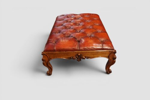 Large Victorian walnut coffee table and stool creating a striking centrepiece in a living room.